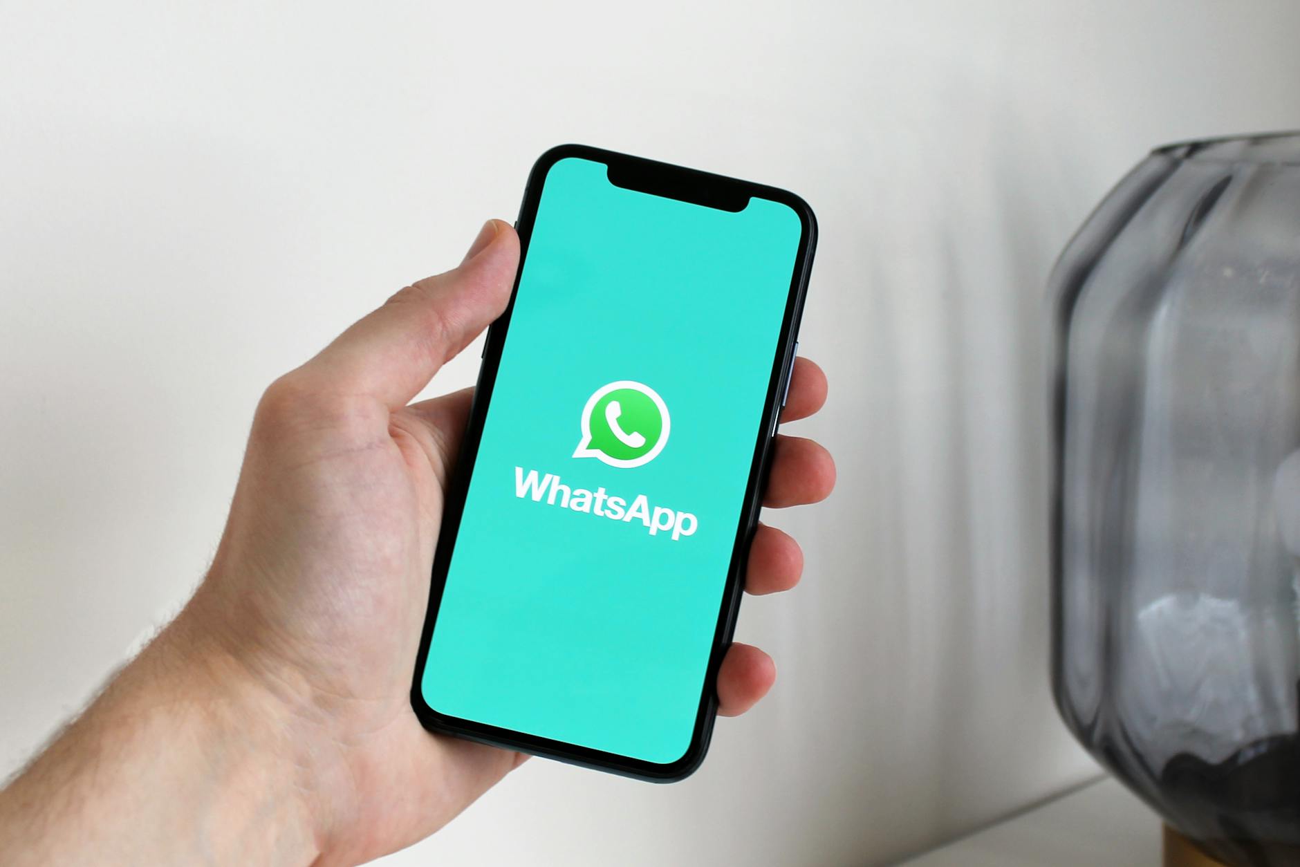 Smartphone displaying WhatsApp conversation with video attachment