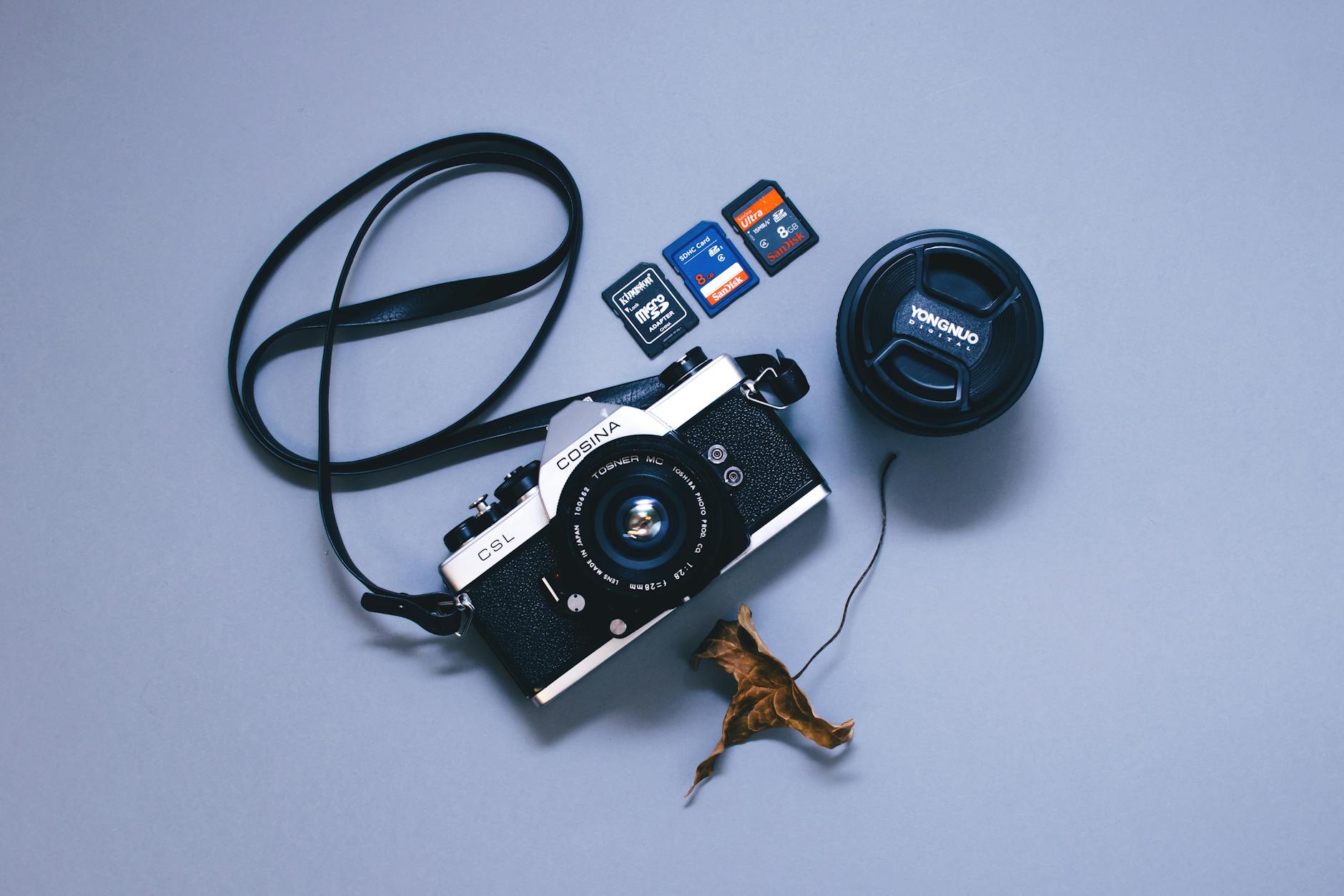 Camera memory card connected to computer showing RAW to JPG batch conversion workflow